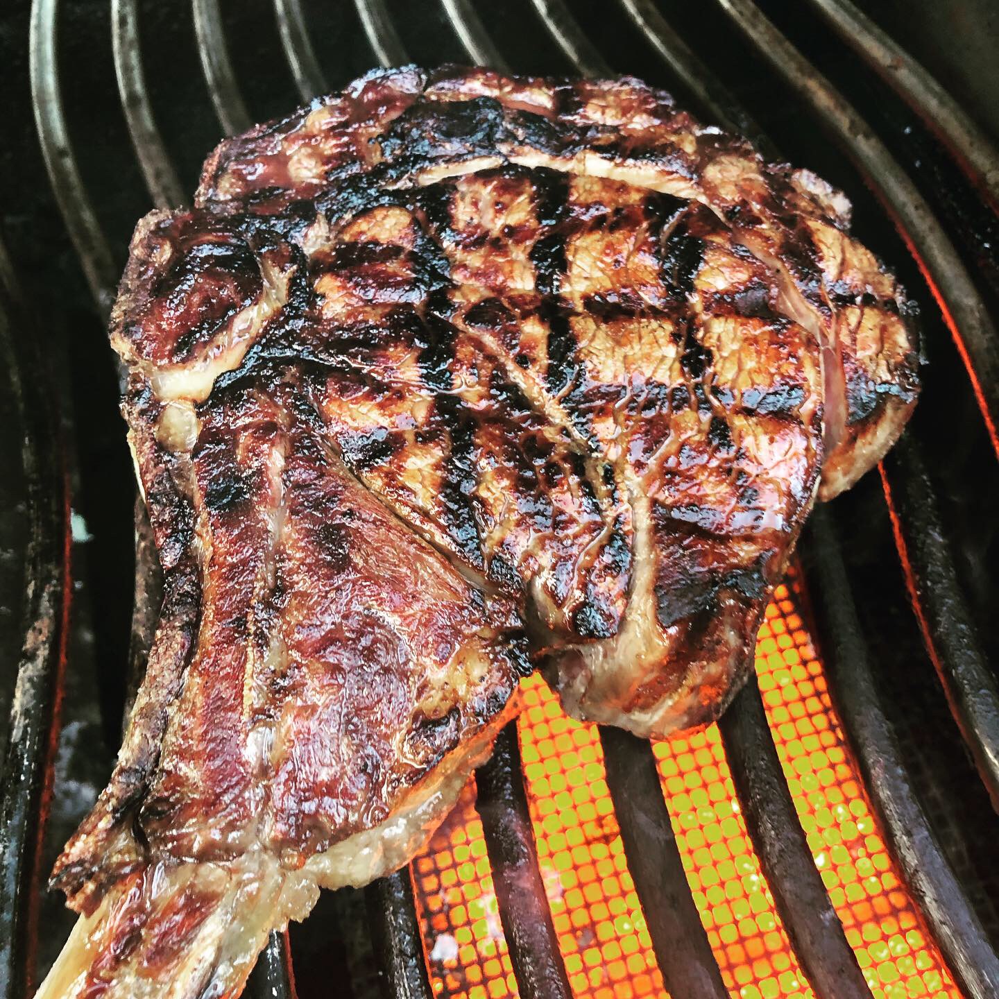 Steak am Knochen über der heißen Grillzone